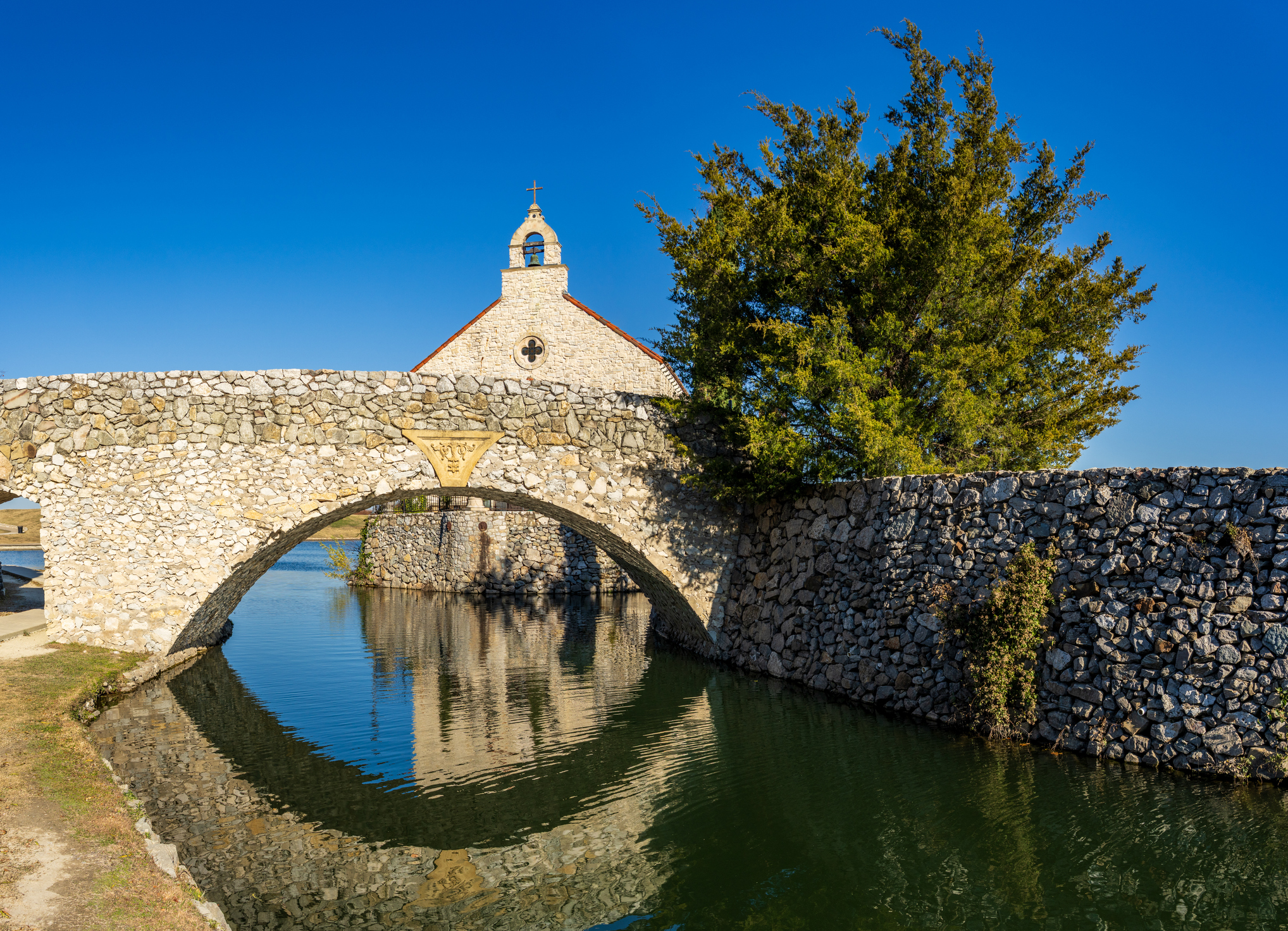 Adriatica cobblestone street with waterfront buildings with chappel in background